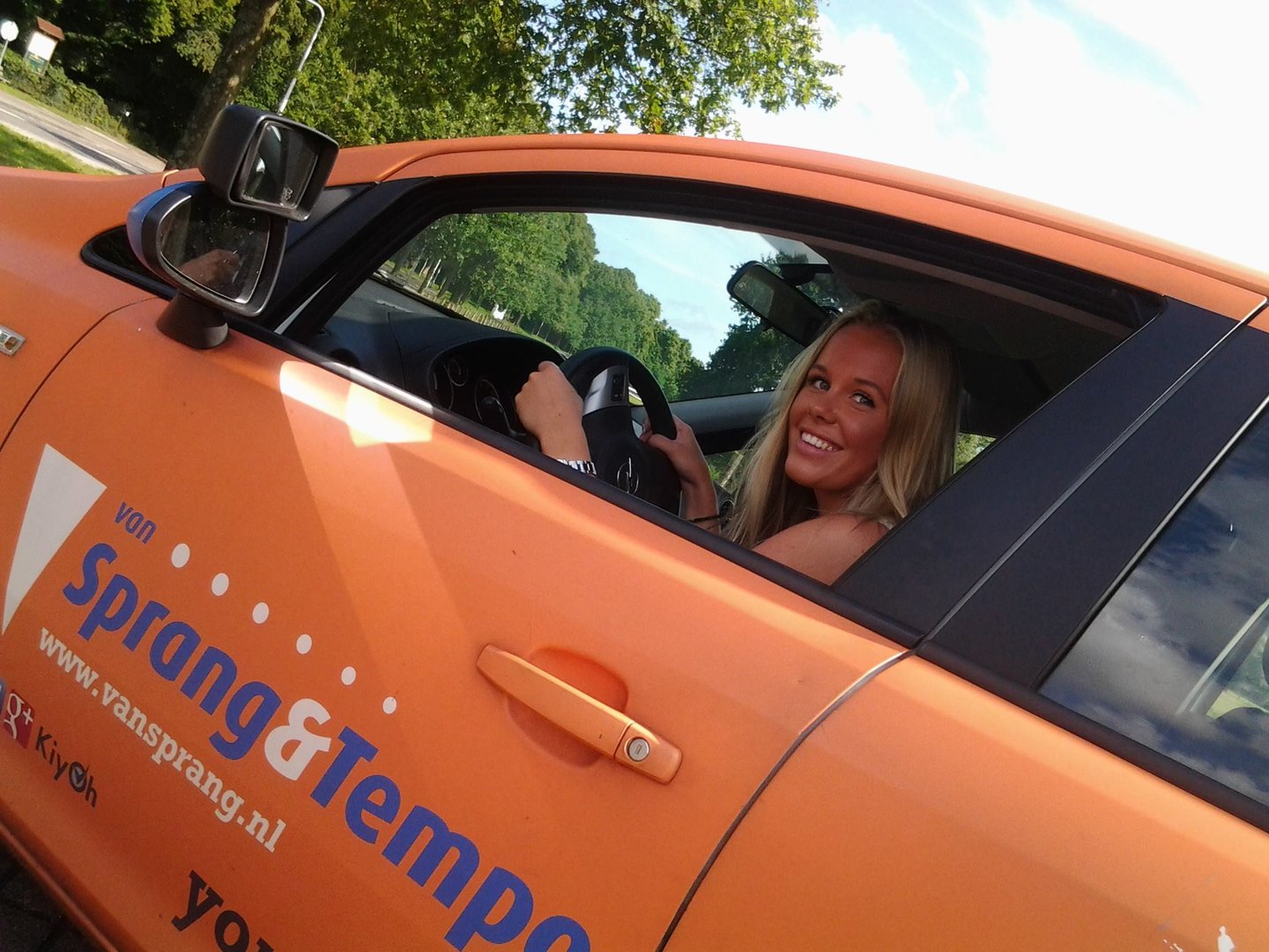 a woman smiling in a car